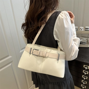 Minimalist cream white PU leather tote bag with belt buckle worn by a model in lifestyle setting