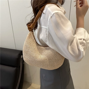 Chic woven straw crescent hobo bag with knotted brown leather strap for summer style