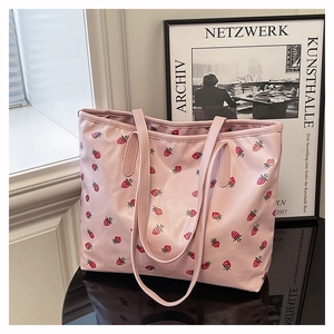 Close-up of pink strawberry print tote bag showing detailed fabric texture and patterns