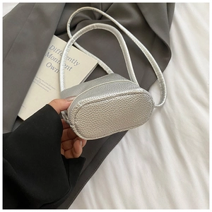 Detail of silver lychee texture on mini bucket bag with thin shoulder strap
