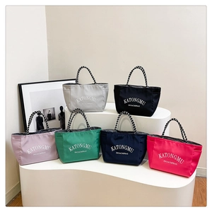 Water-resistant commuter tote bags in six colors with unique woven rope handles