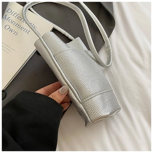 Detail of silver lychee texture leather on a minimalist mini crossbody phone bag