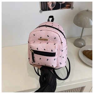 Detail of pink mini backpack with crinkle texture, bow print and gold logo