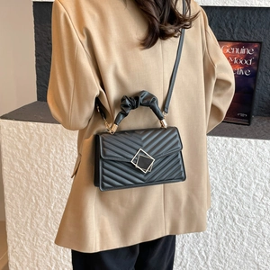 Chic black V-quilted crossbody bag with ruched handle and elegant gold-tone square buckle