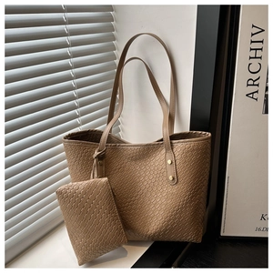 Detail of woven texture large tote bag with matching zippered pouch and leather strap