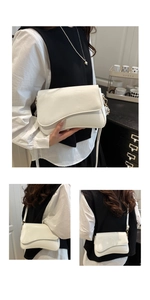 Detail view of white patent leather shoulder bag with irregular flap and glossy mirror finish
