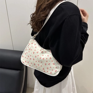 Chic white hobo bag with red cherry print and slender shoulder strap for daily wear