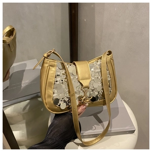Detail of sequins stitching and gold metal buckle on a metallic shoulder bag