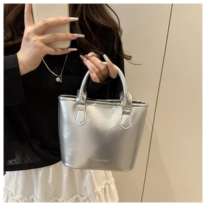 Detail of silver metallic bucket bag featuring Fashion & Bags logo and smooth texture