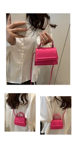 Detail of a rose pink mini crossbody bag with top handle and leather strap for women