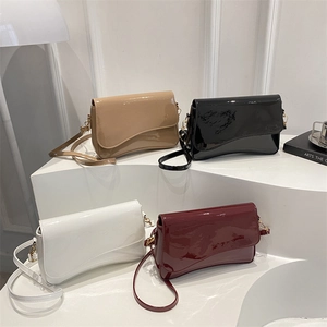 Glossy patent leather shoulder bag with asymmetrical flap in white, red, black and beige