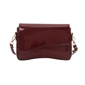 Minimalist glossy wine red patent leather shoulder bag with unique curved base design
