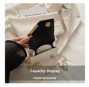 Detail view of white mini crossbody bag interior showing storage space for makeup compact