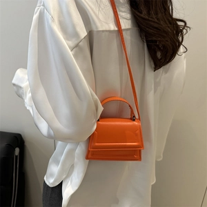 Minimalist bright orange mini square bag with top handle and crossbody strap for women