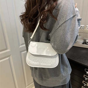 White woven texture crossbody bag with gold lettering shown on model for daily style