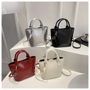 Detail view of stylish bucket bags in four colors with glossy finish and metal hardware