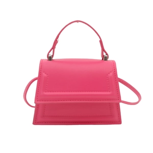 Neon pink minimalist leather crossbody bag with top handle and trapezoid shape