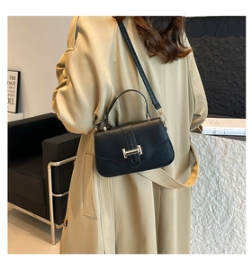 Litchi pattern crossbody bag with gold lock buckle and leather handle in daily use