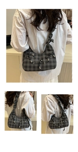 Detail of grey plaid hobo bag with black bows and metallic beads on ruched shoulder strap