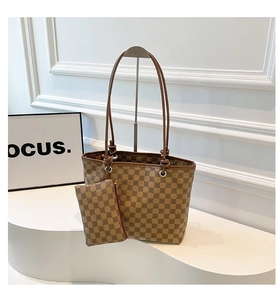 Detail view of brown checkered tote bag set with matching small zipper pouch on a display stand