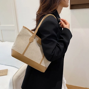 Minimalist canvas and leather contrast tote bag with shoulder strap for daily commuting