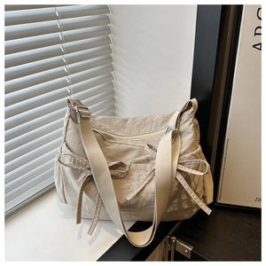 Detailed view of lightweight nylon tote bag featuring side bows and adjustable strap