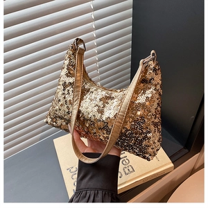 Detail of shimmering gold sequins on a trendy hobo bag with sleek zipper closure