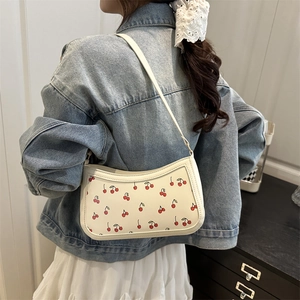 White crescent underarm bag with cherry print and matching strap for stylish summer wear