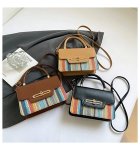 Detail shot of woven straw patchwork bags with chic gold metal buckles and crossbody straps