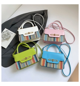 Detail of woven straw crossbody bags in four colors with elegant gold metal locks