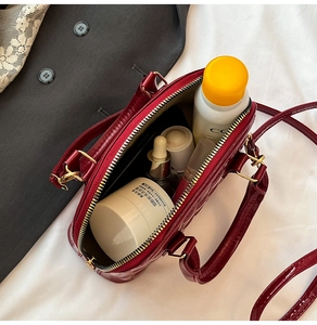 Interior view of deep red quilted shell bag showing storage capacity for cosmetics
