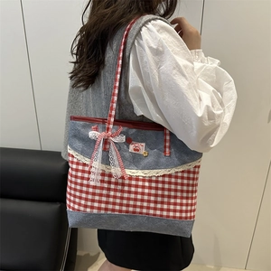 Sweet denim patchwork tote bag with red checkered bow and lace trim on a model