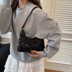 Modern black sequin hobo bag with adjustable leather strap for a stylish casual summer look