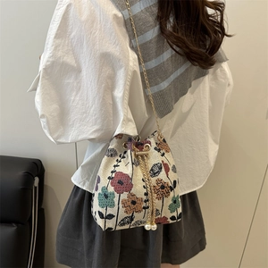 Ethnic style bucket bag with floral jacquard, pearl drawstring and gold chain strap