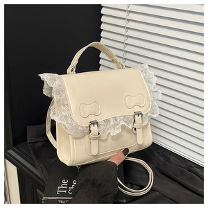 Détail du sac à main crème en PU avec bordure en dentelle et coutures décoratives en nœud