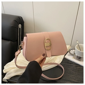Close-up of pink leather shoulder bag featuring a luxury gold oval metal buckle detail