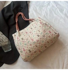 Detail of white bubble textured tote bag with pink cartoon bear print and braided handles