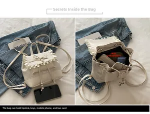 Detail view of lace trim backpack interior capacity with bow and pearl accents