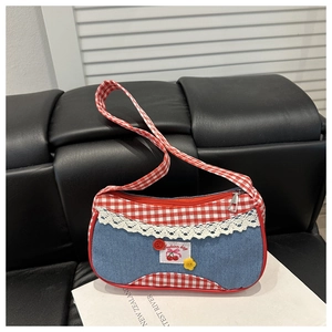 Detail of plaid denim handbag with cherry patch, lace trim and button accents
