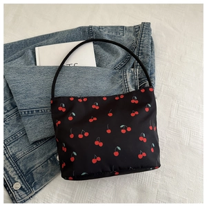 Detail of black cherry print tote bag made of lightweight nylon with single handle