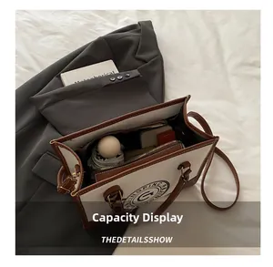 Interior view showing the large capacity and compartments of the canvas tote bag
