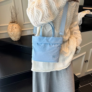 Sac à main bleu clair matelassé avec bandoulière large et style pull en maille doux