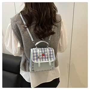 Mini gingham backpack with apple print shown on model for size and style reference