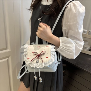 Light blue balletcore mini backpack with white lace trim and red ribbon bows
