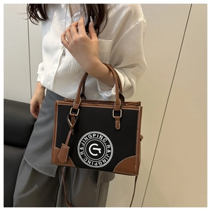 Lifestyle shot of model carrying a black and brown leather tote bag with round logo