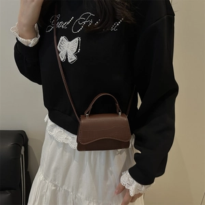 Brown crocodile pattern mini crossbody bag with wavy flap design for women