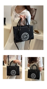 Multiple views showing a black leather tote with white contrast stitching and G logo