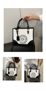 Detail of canvas tote bag showing black PU leather trim and printed circular logo