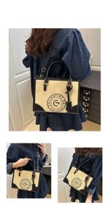 Detail of vintage canvas tote with black leather trim and printed graphic logo