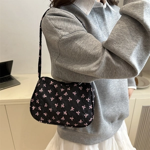 Hobo shoulder bag with pink bow embroidery on black fabric for a chic aesthetic